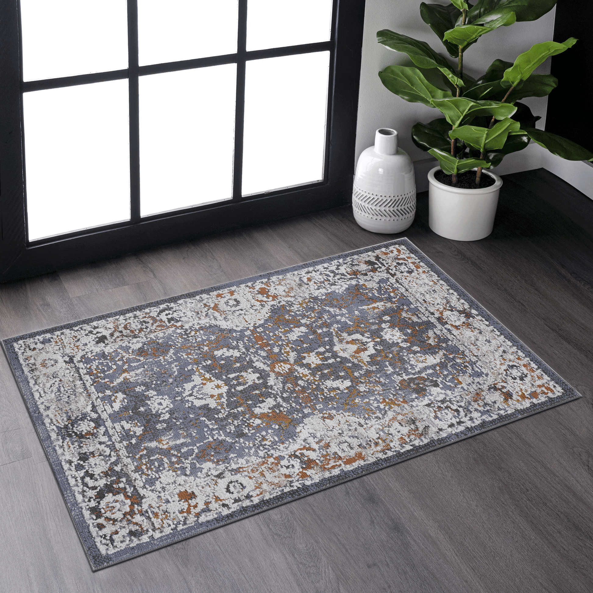 Distressed oriental rug in gray and rust adding vintage charm to any room