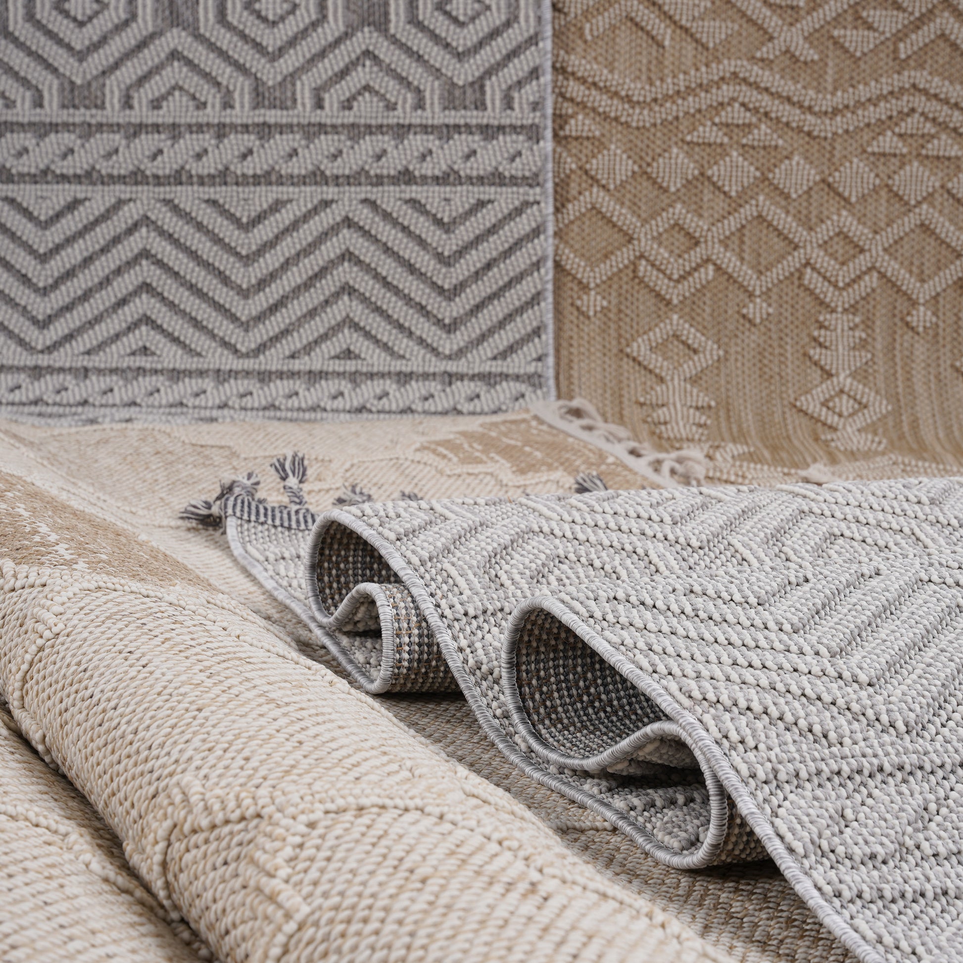 Textured grey geometric pattern indoor rug with fringed edges