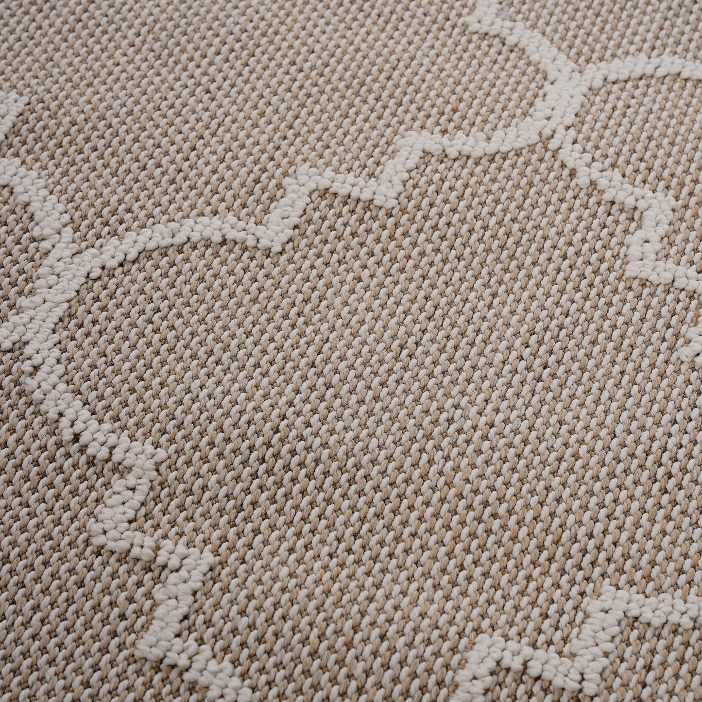 Textured beige rug with a subtle geometric white pattern ideal for a living room