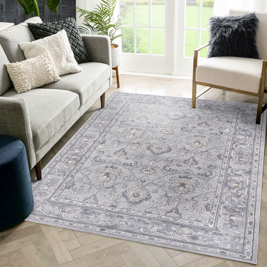 Gray distressed Persian rug with floral patterns and ornate border