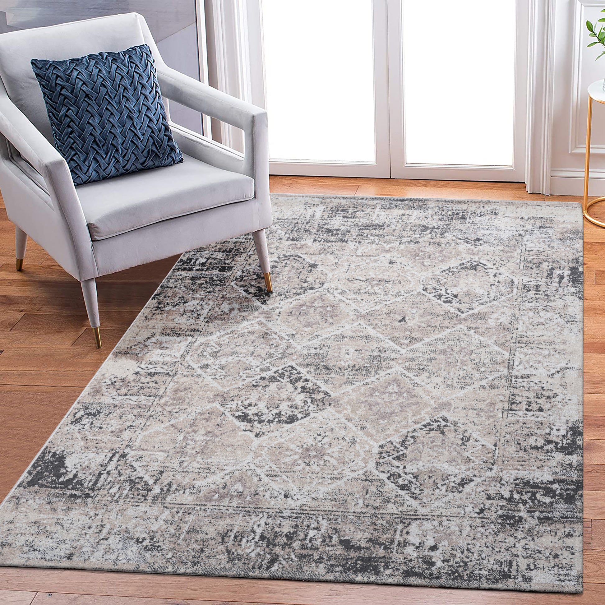Distressed grey and beige area rug with abstract diamond pattern