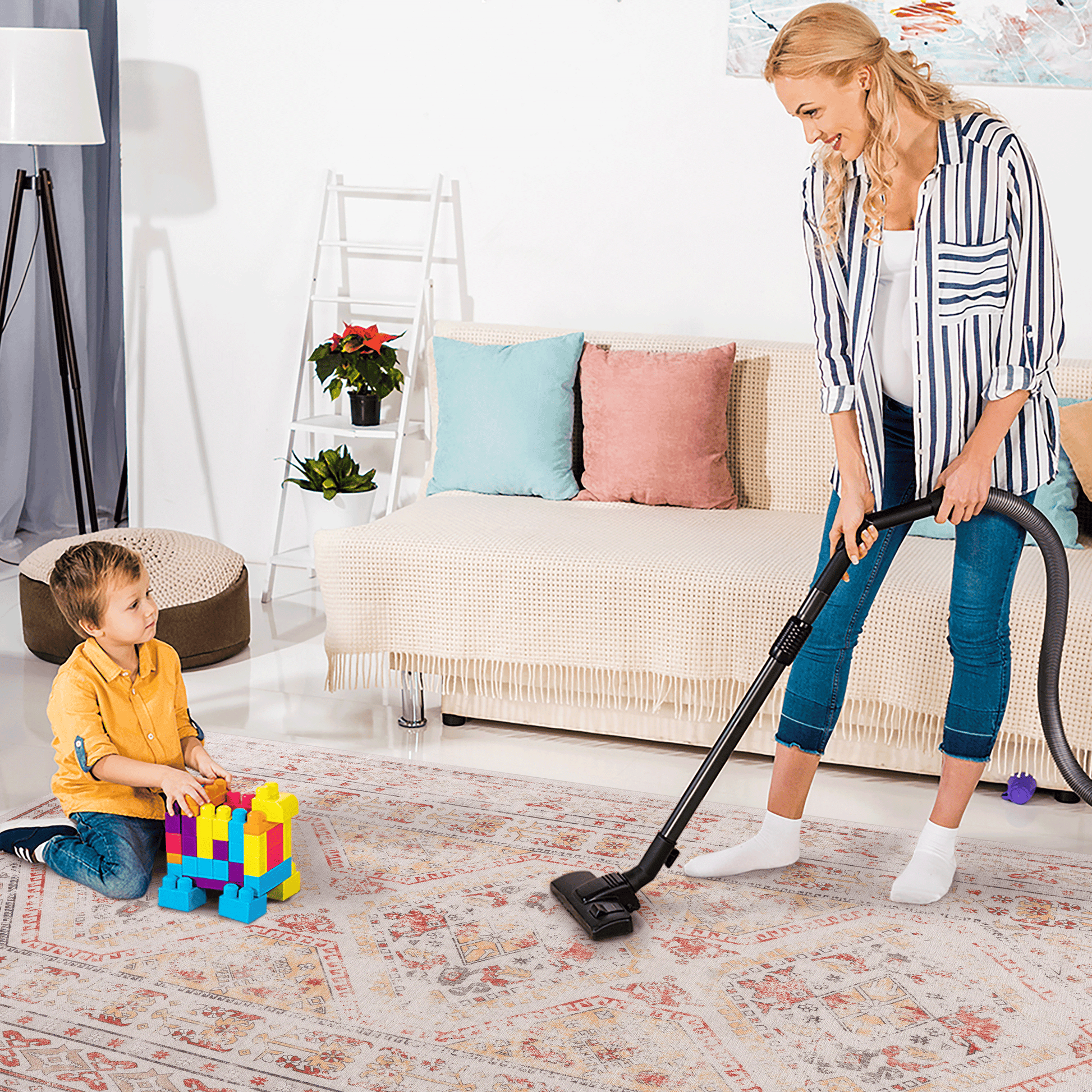 Lightweight vacuum cleaner with a child playing with colorful blocks on an oriental rug