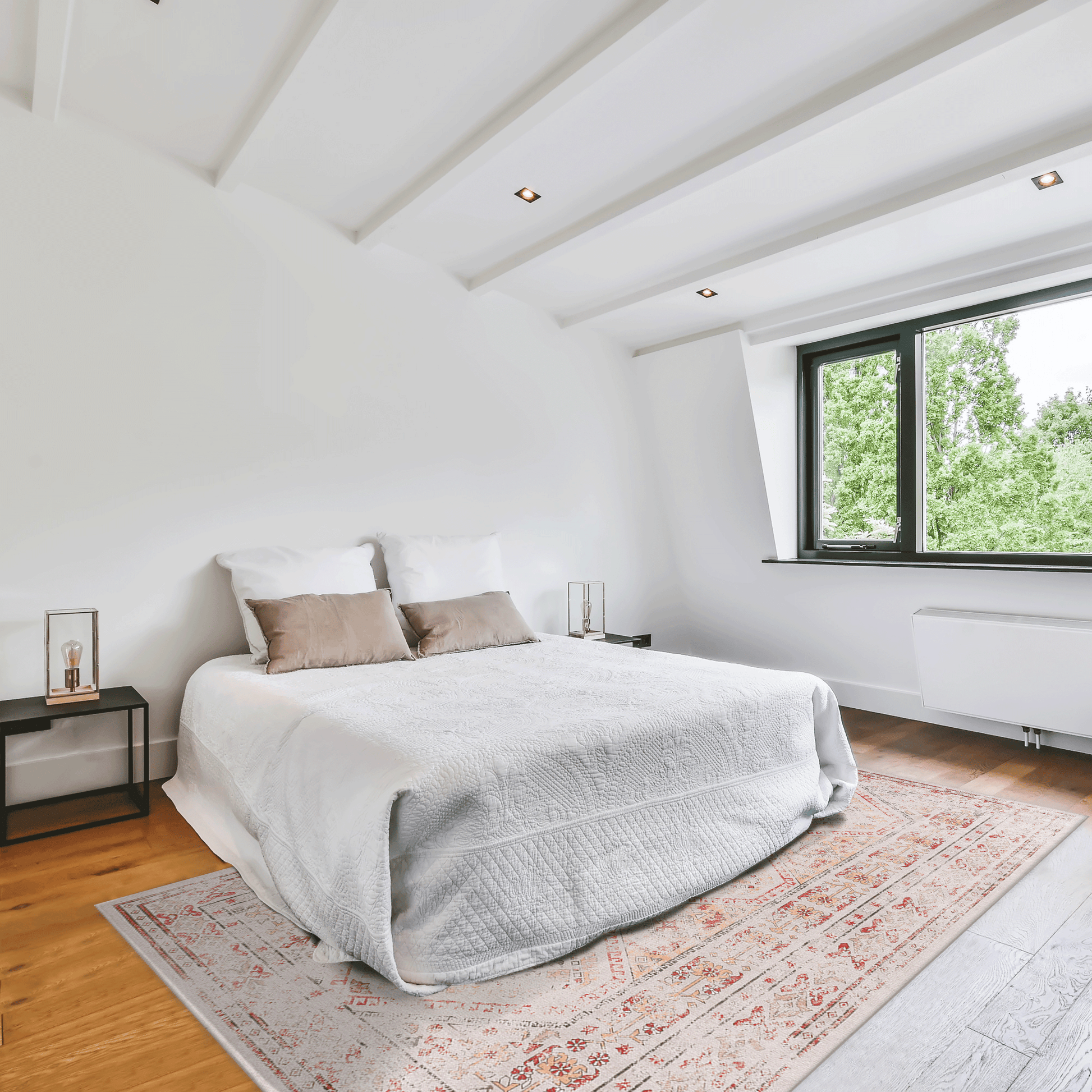 White quilted bedspread with neutral decorative pillows on a master bedroom