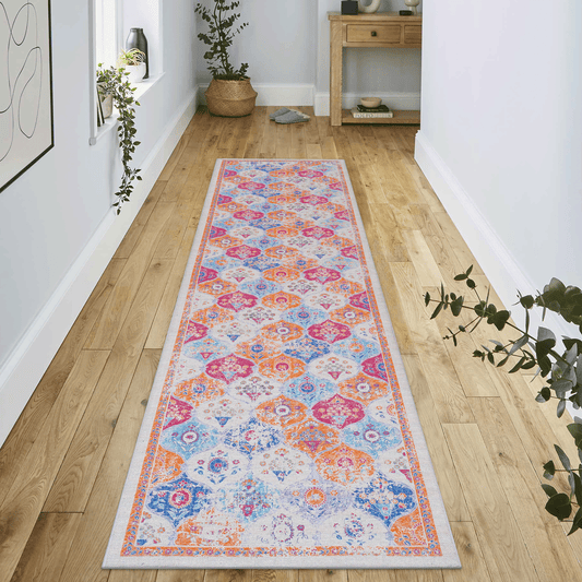 Abstract medallion hallway runner rug with vibrant orange blue and pink hues