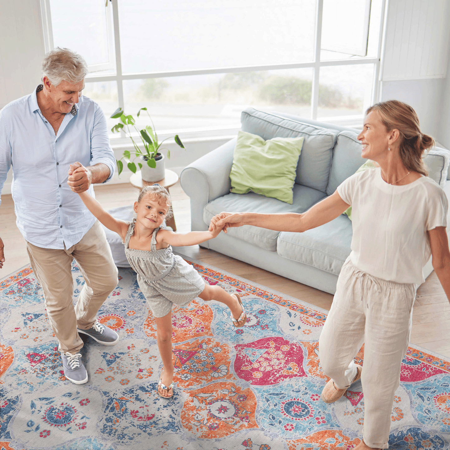 Ornate bohemian area rug in cream with vibrant orange pink and blue mandala patterns perfect for living rooms