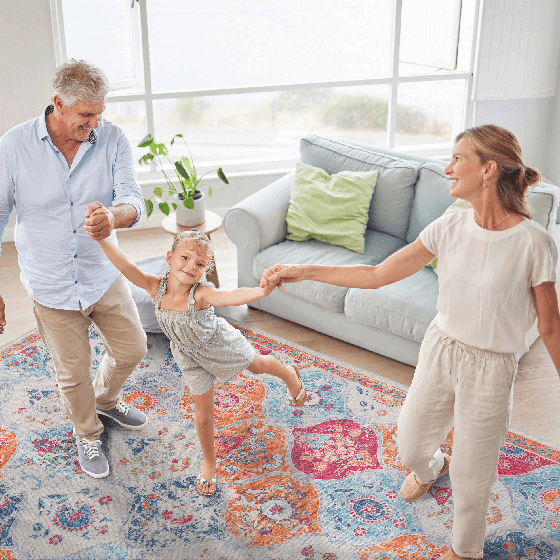 Ornate bohemian area rug in cream with vibrant orange pink and blue mandala patterns perfect for living rooms
