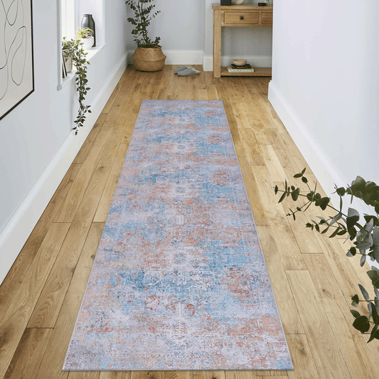Distressed traditional runner rug in shades of blue orange and grey adds vintage charm to hallway floors
