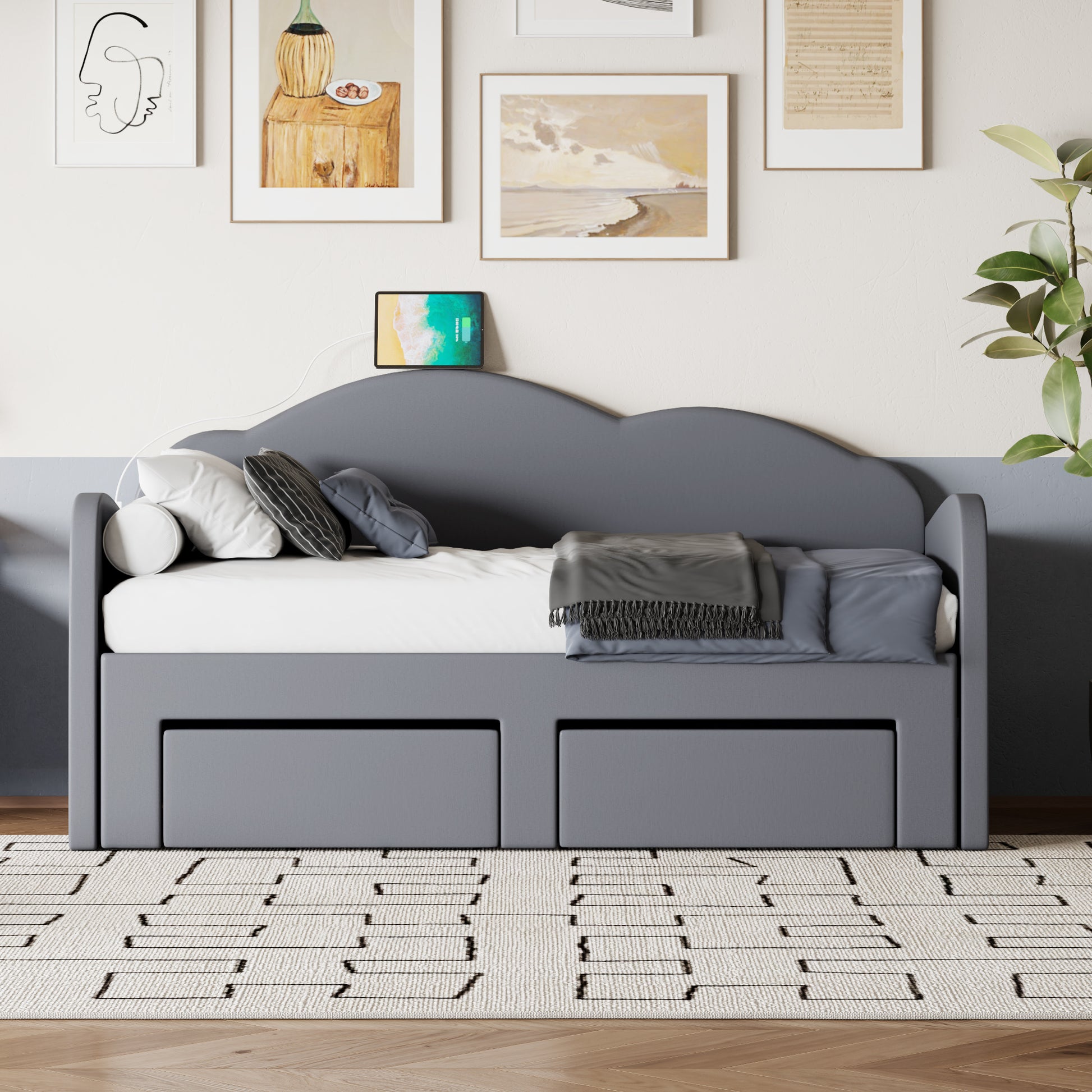 Gray upholstered daybed with cloudshaped headboard and two storage drawers
