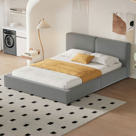 Grey upholstered platform bed with a mustard accent throw and pillows