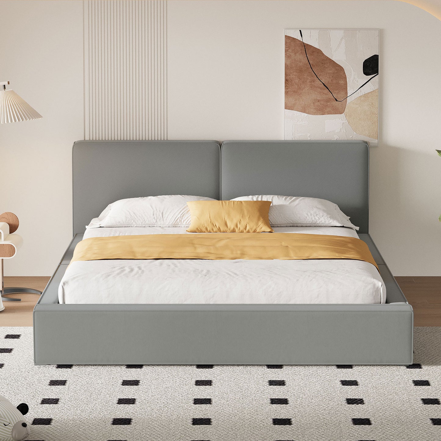 Modern grey upholstered platform bed with white linens and yellow accent pillow