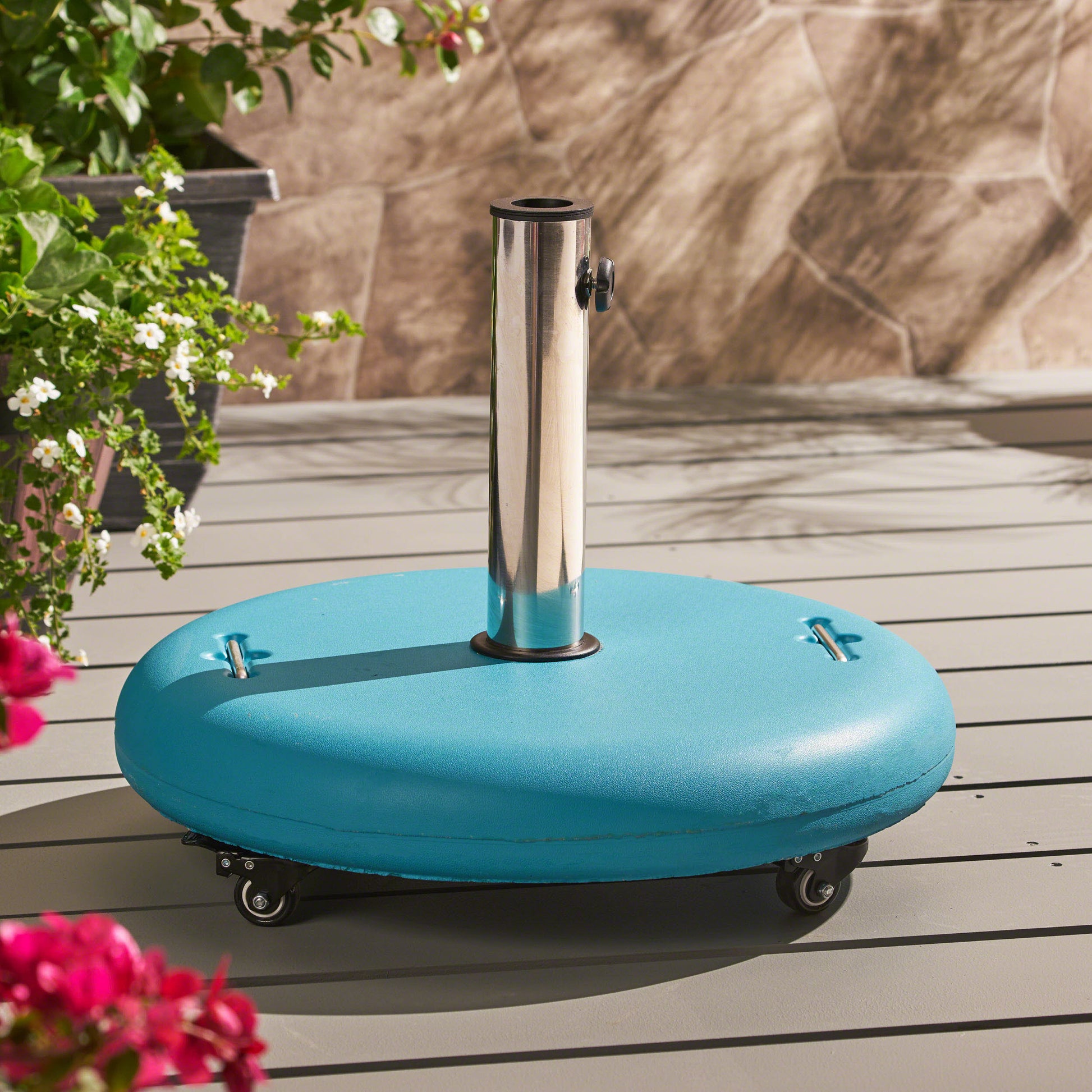 Turquoise patio umbrella base with silver pole and wheels for outdoor stability