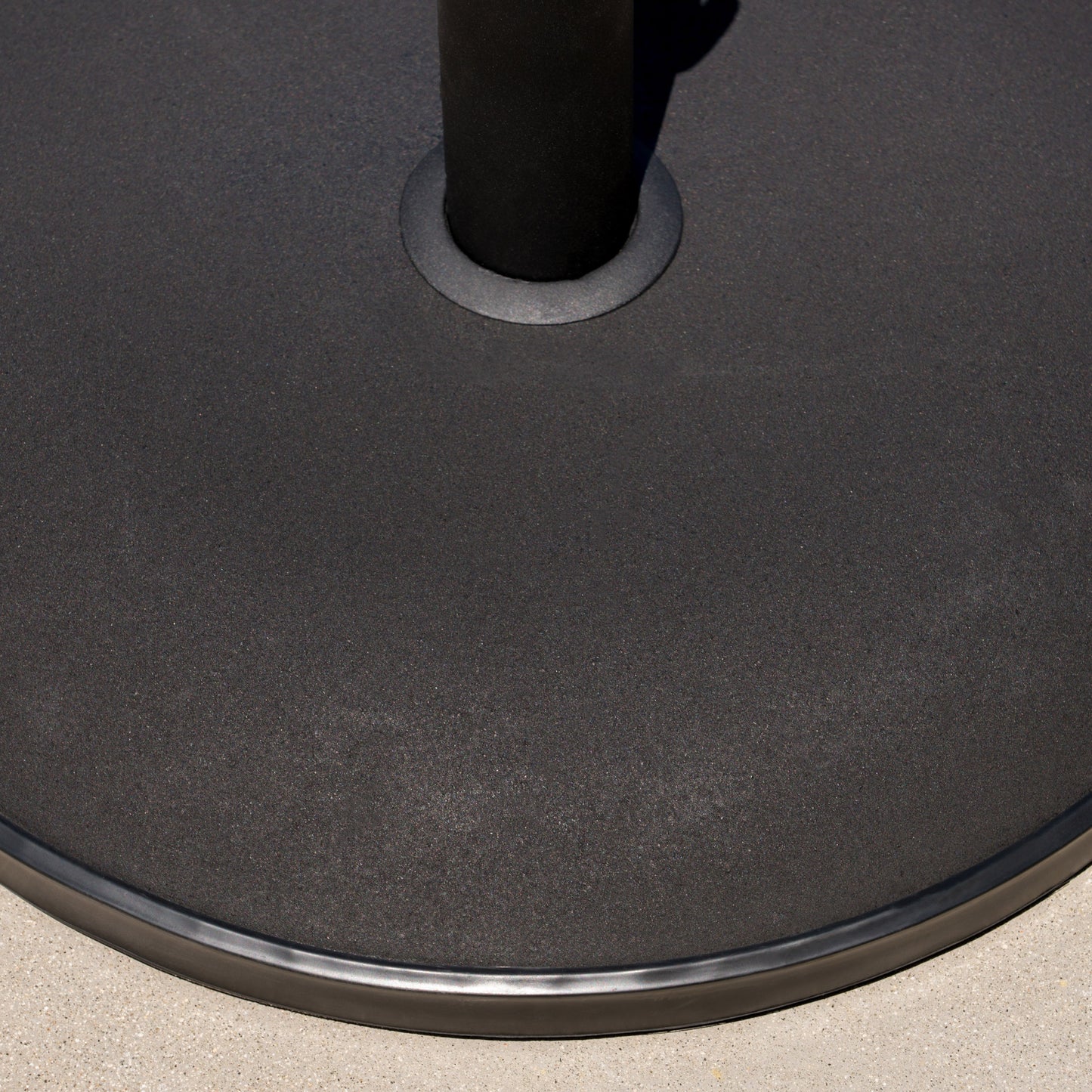 Heavyduty black metal patio umbrella base with textured finish and rubberized edge for stability