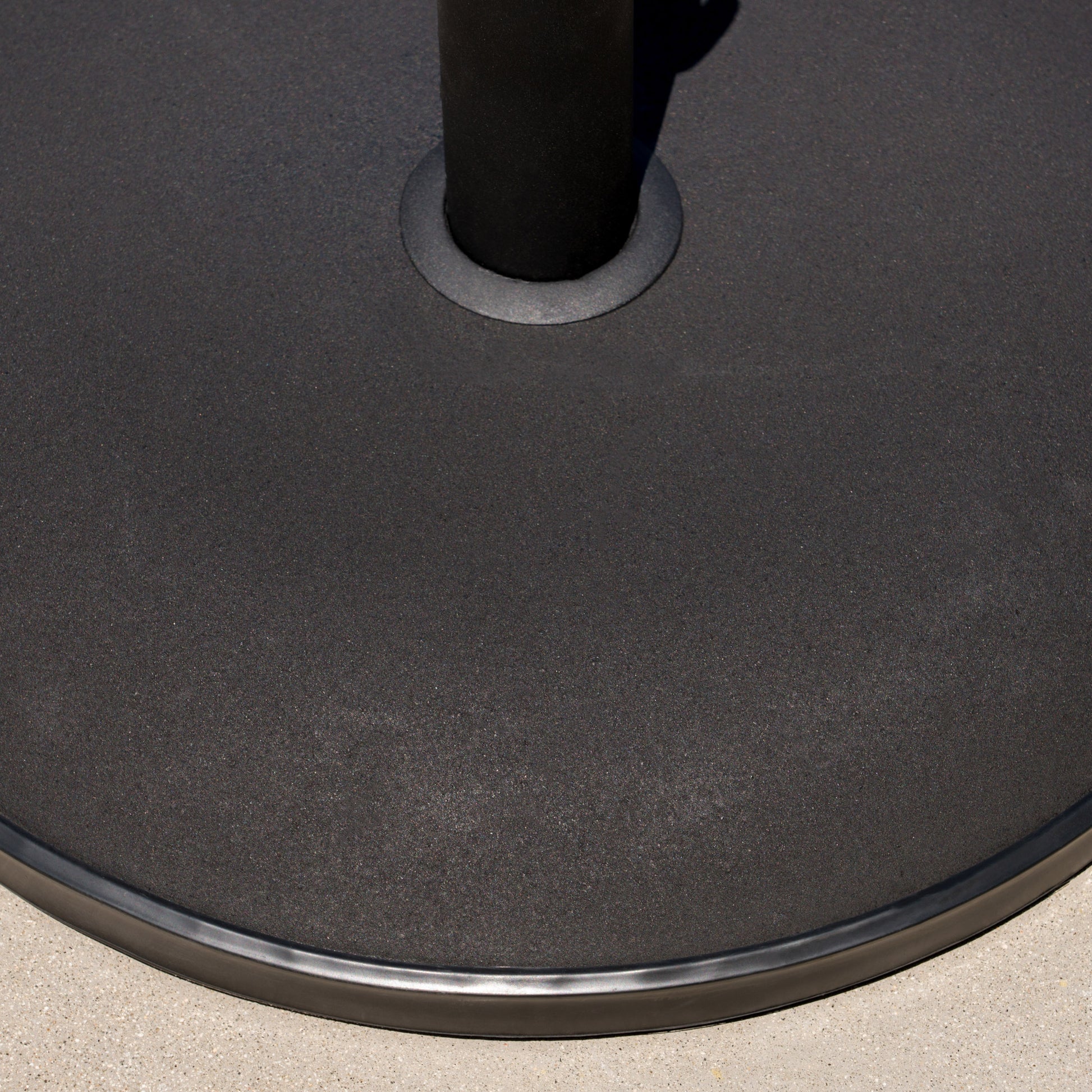Heavyduty black metal patio umbrella base with textured finish and rubberized edge for stability