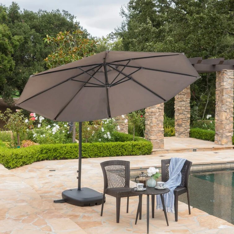 Large taupe patio umbrella with black pole and heavy base open for shade