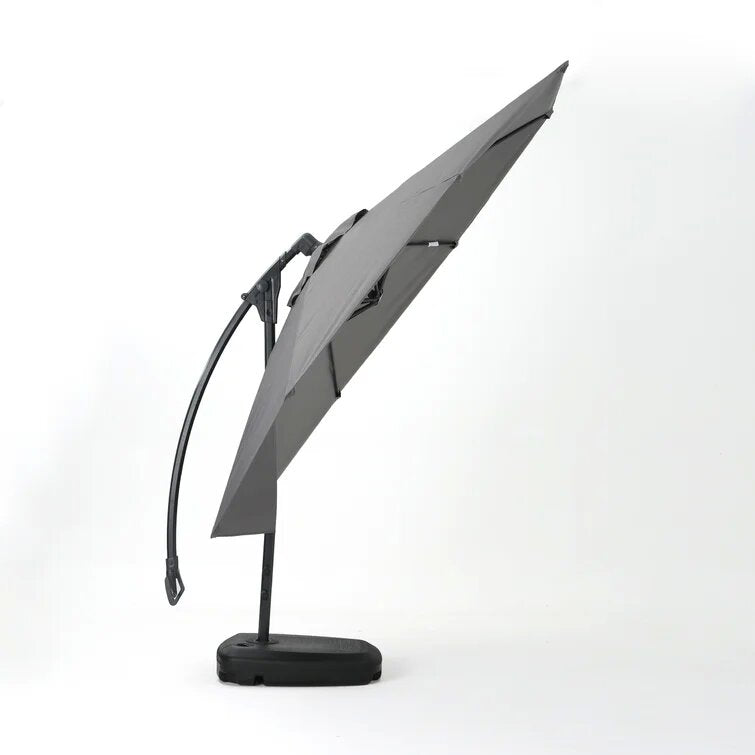 Gray cantilever umbrella with a curved arm and black base for patio shade