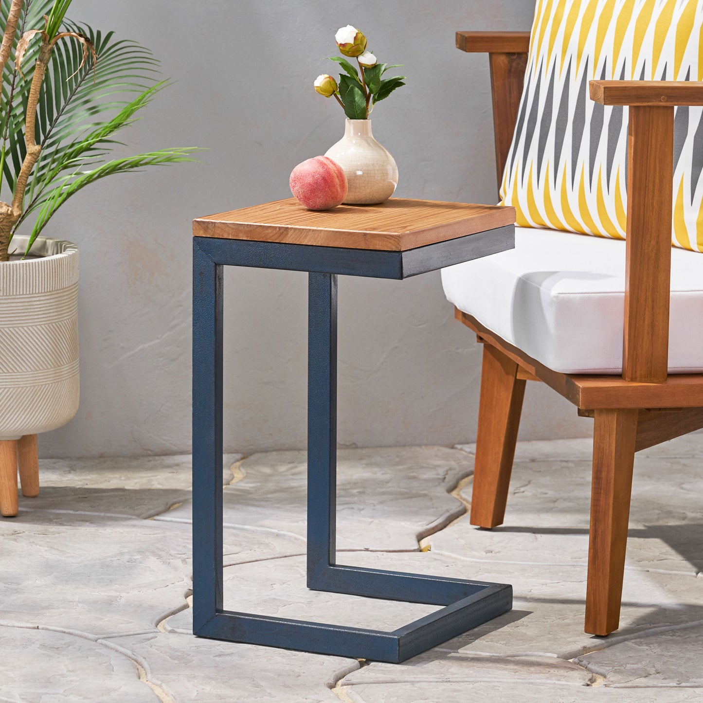 Cshaped side table with a natural wood top and dark blue metal frame