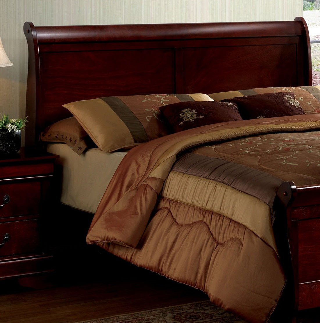 Dark cherry sleigh bed with upholstered headboard