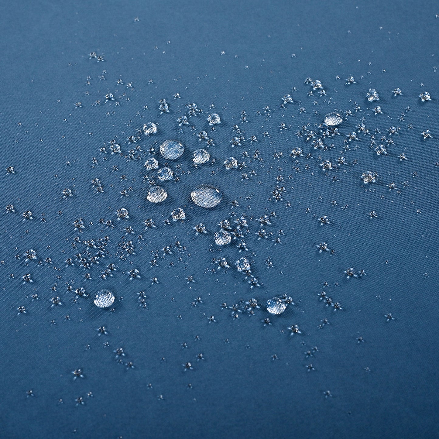 Blue fabric with water repellent treatment beading water droplets