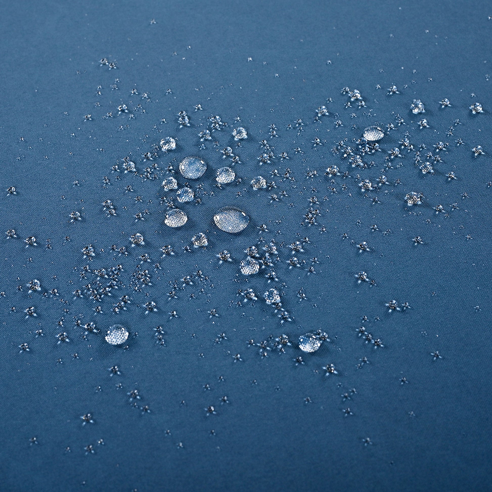 Blue fabric with water repellent treatment beading water droplets