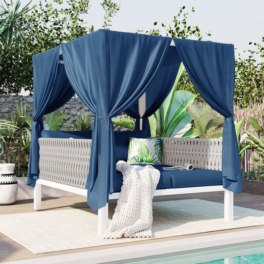 Blue canopy daybed with white woven sides and plush cushions for outdoor lounging