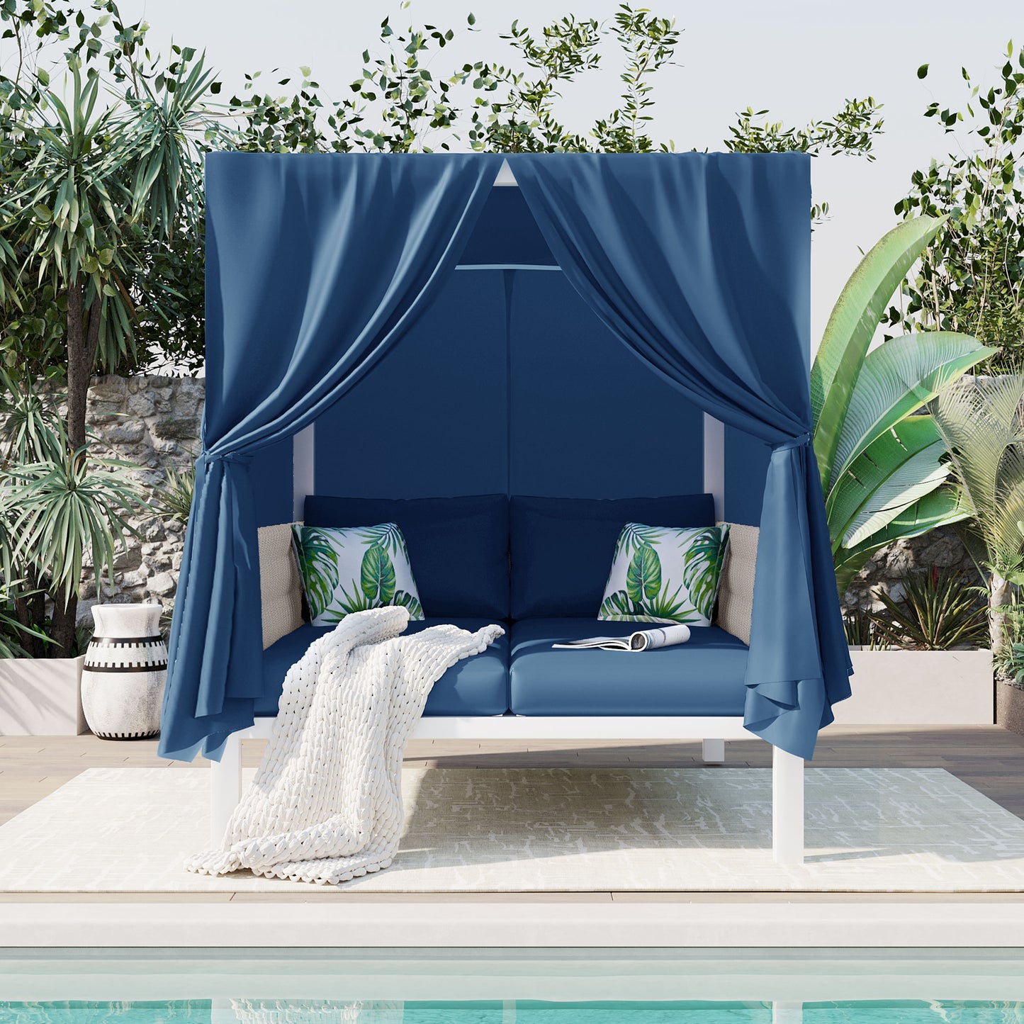 Blue outdoor daybed with canopy and tropical print pillows ideal for poolside relaxation