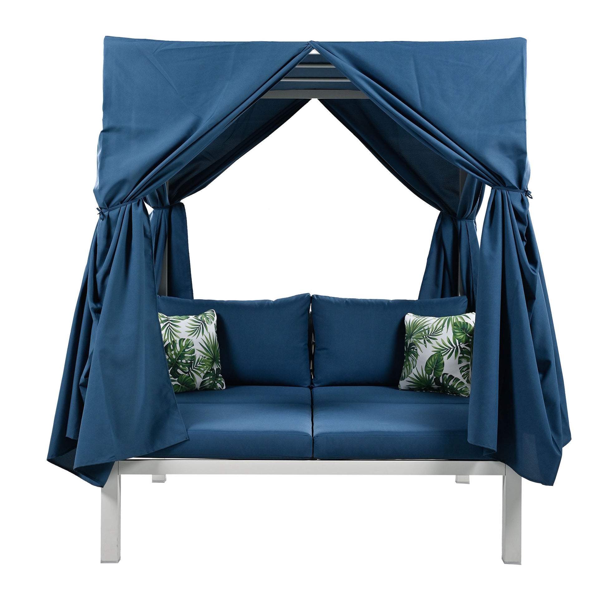 Blue outdoor canopy daybed with white frame and tropical leaf accent pillows
