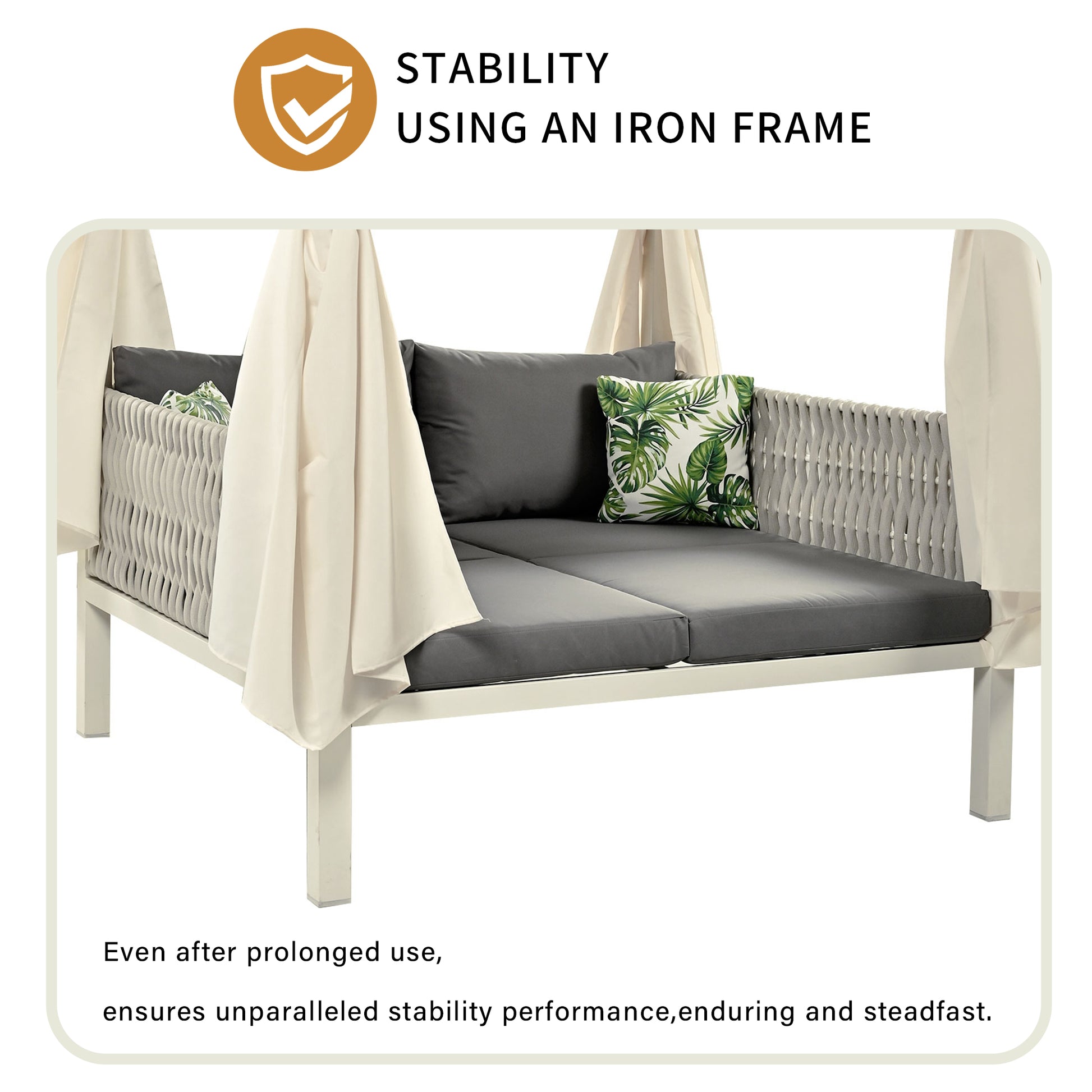 Outdoor daybed with cream canopy gray cushions and tropical accent pillow on an iron frame