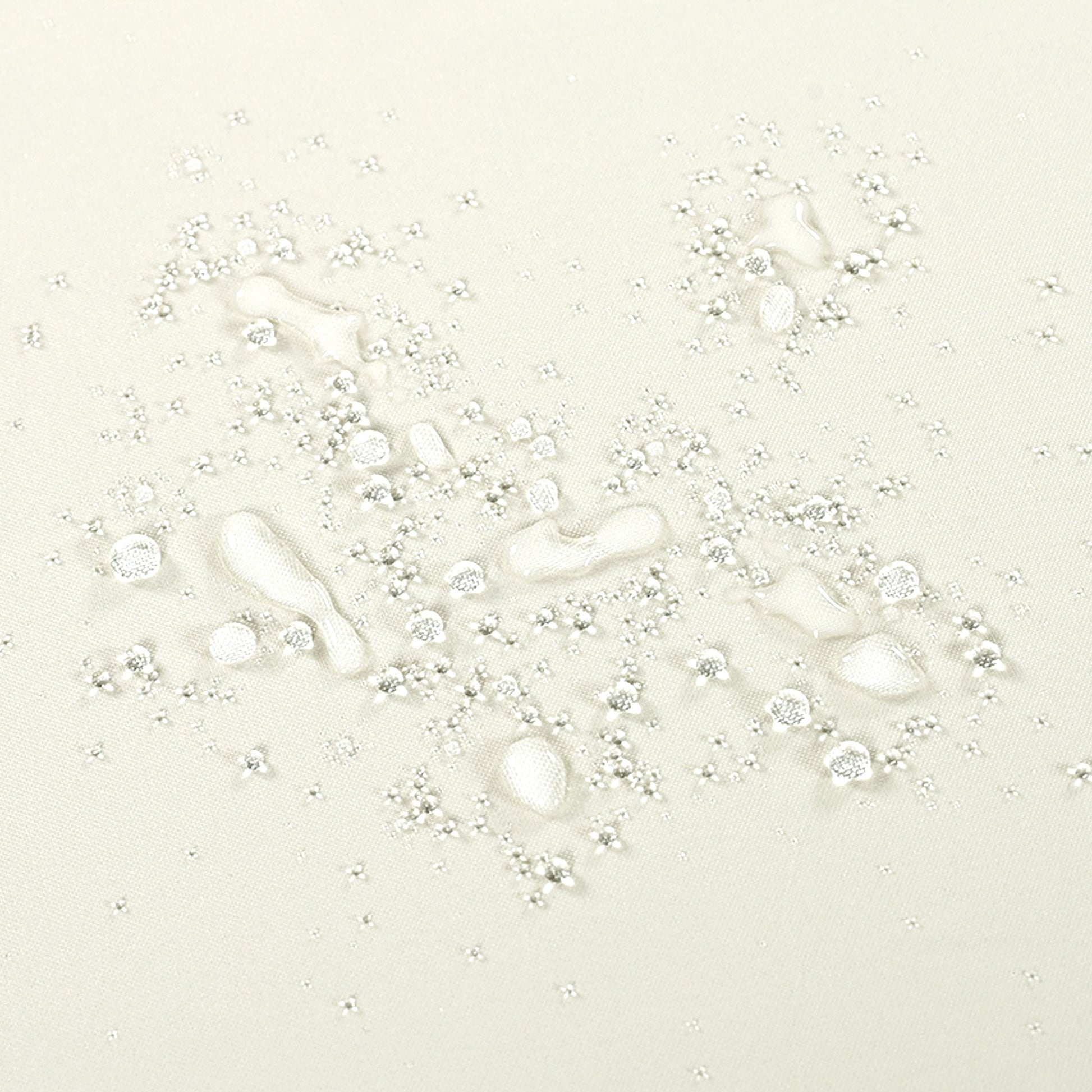 Light beige textured fabric with water beads showing its waterresistant quality