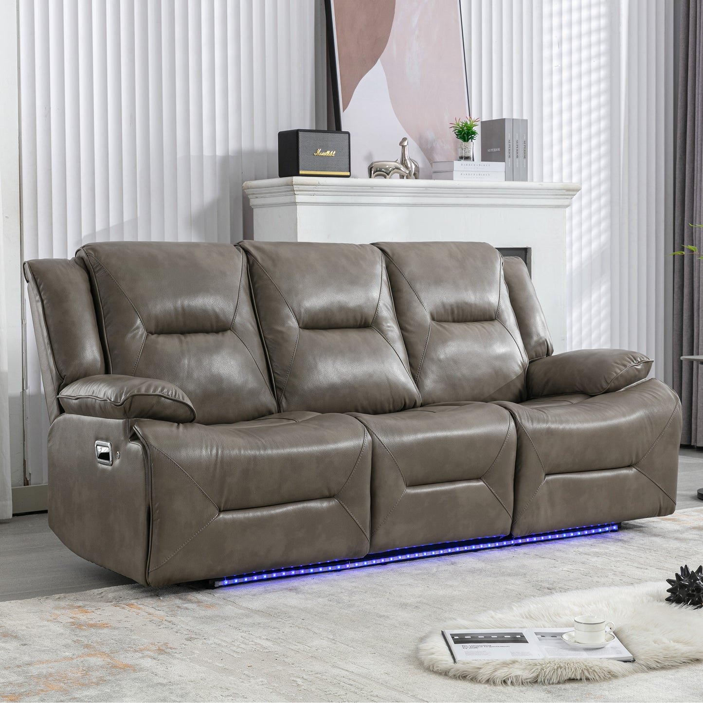 Gray leather threeseater recliner sofa with chrome levers and blue LED ambient lighting