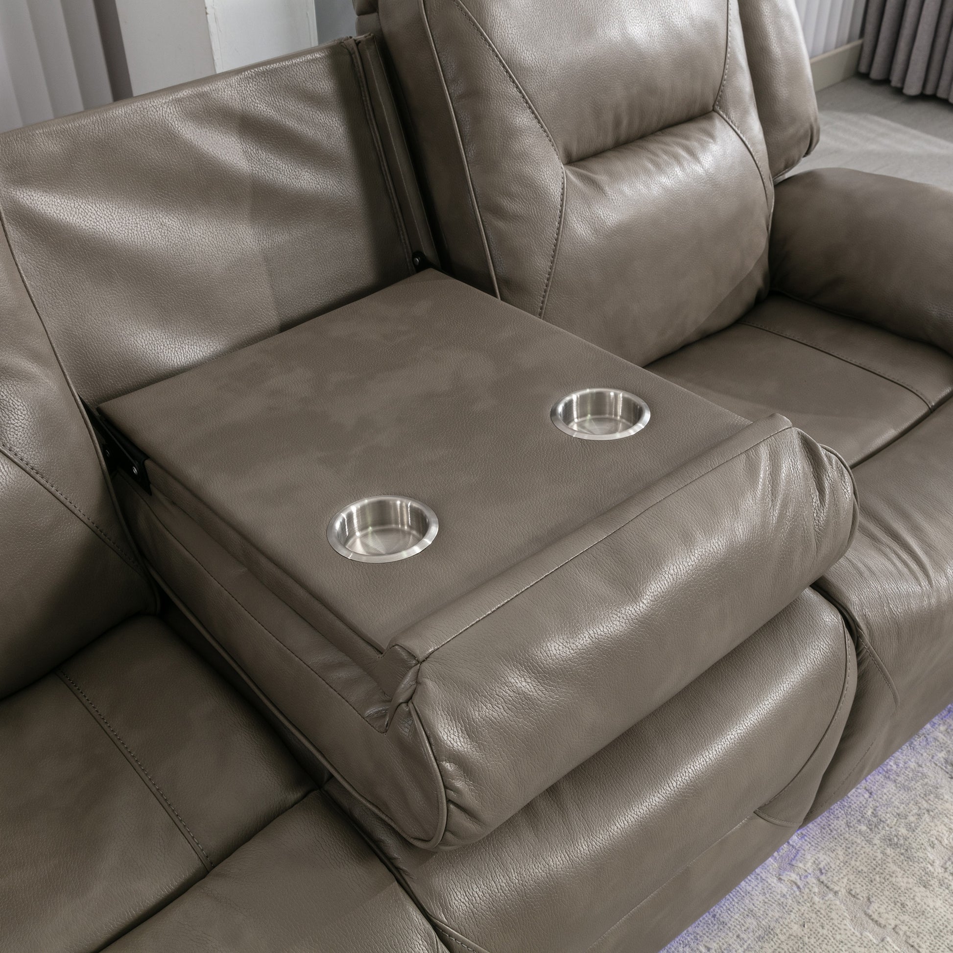 Taupe leather reclining sofa with integrated dual cup holder console