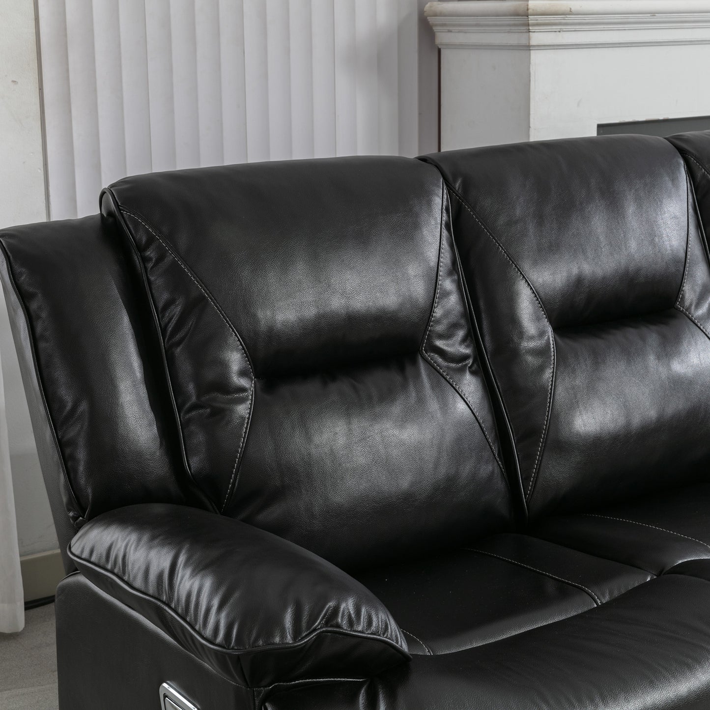 Black faux leather recliner sofa with stitched detailing and plush cushioning