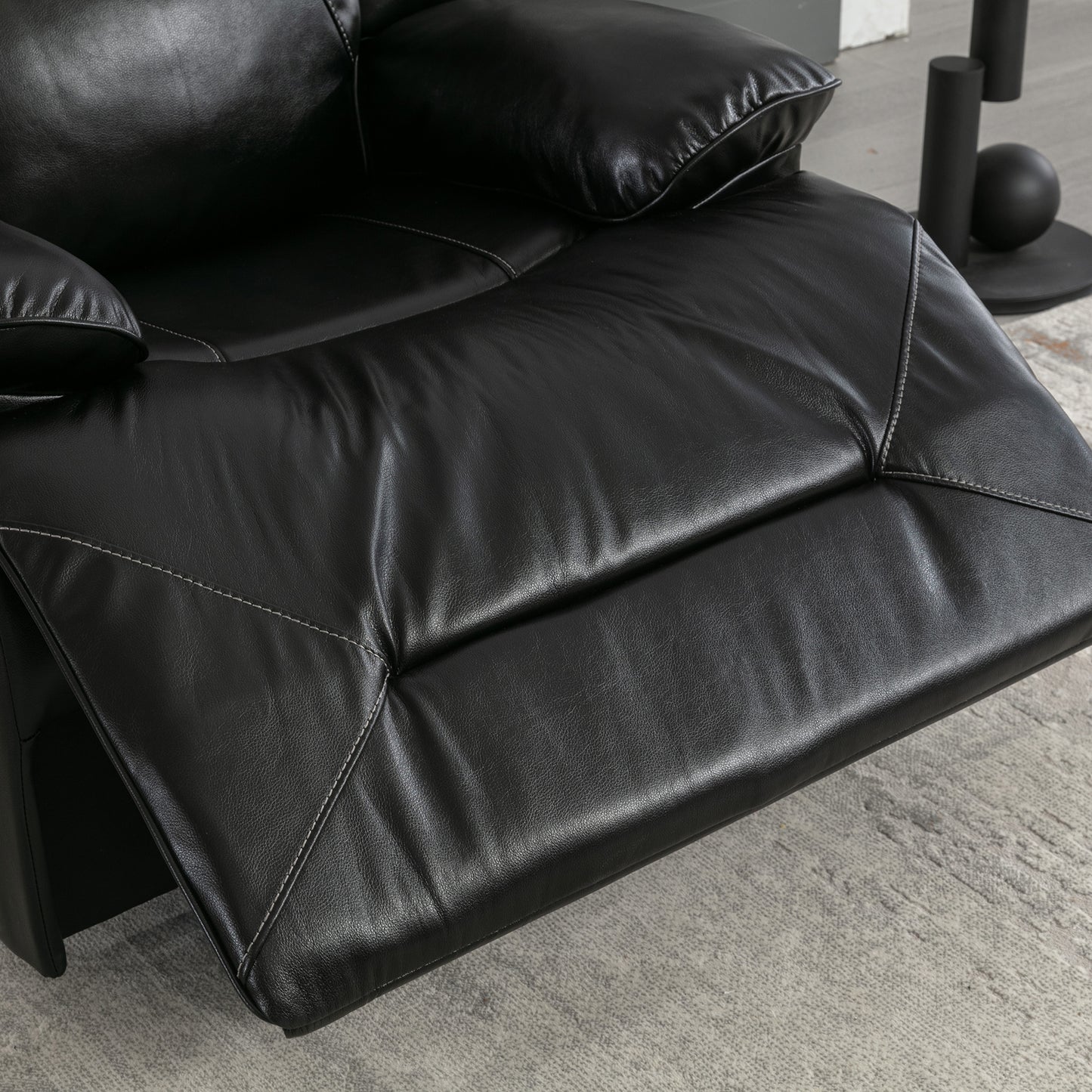 Black leather recliner footrest with white contrast stitching plush seating