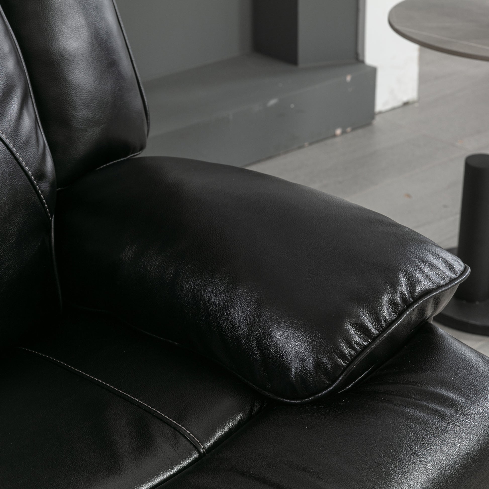 Plush black leather sofa armrest with detailed stitching a comfortable seating option