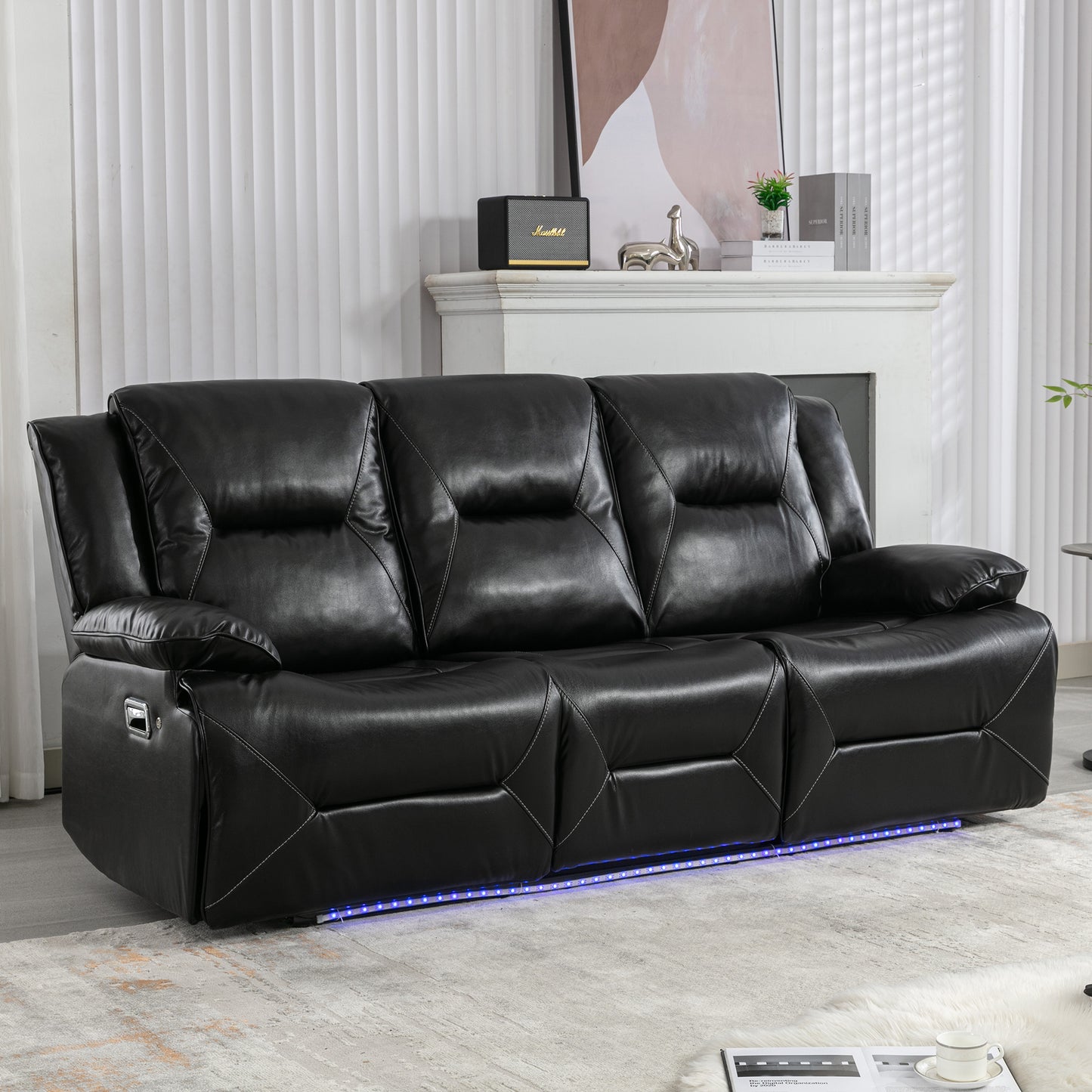 Black leather recliner sofa with white stitching and LED base lighting