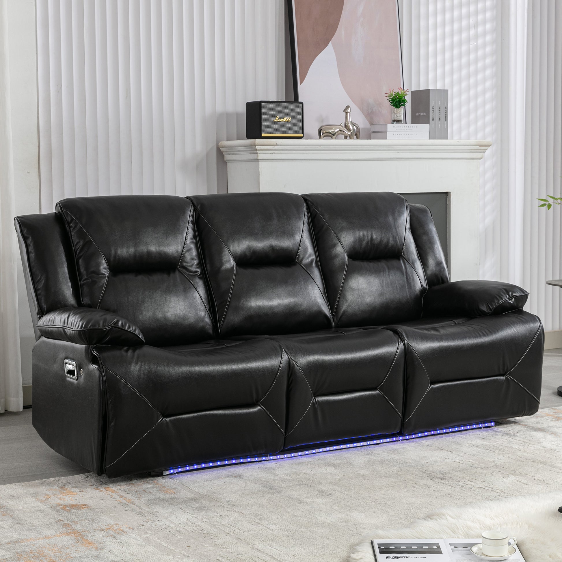 Black leather recliner sofa with white stitching and LED base lighting