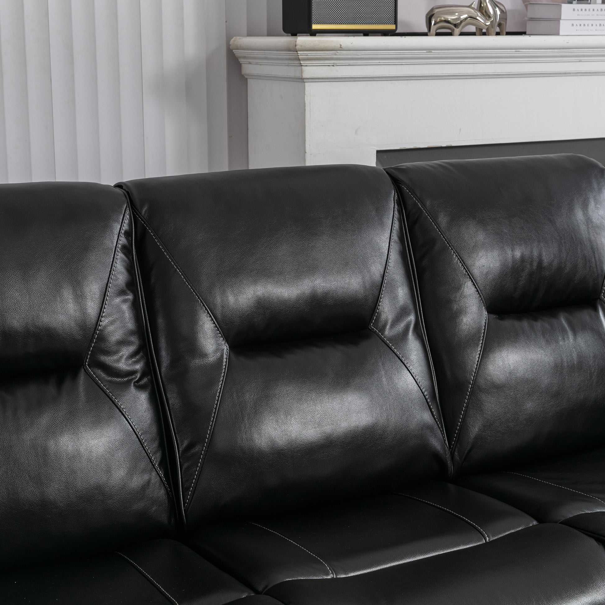 Closeup of a black leather sofa with diamondstitched cushioning highlighting its modern design and material