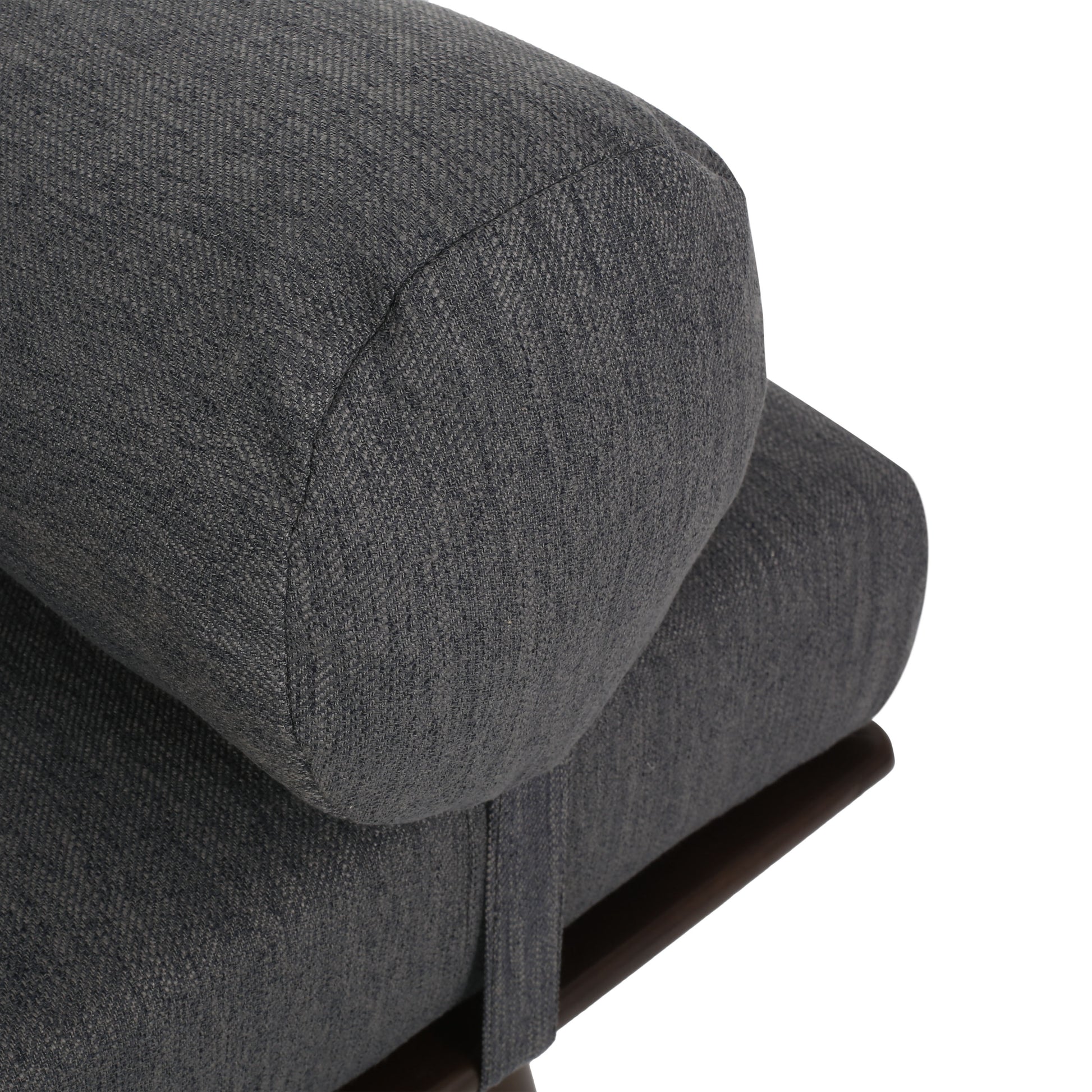 Closeup of charcoal grey textured fabric bolster on modern sofa