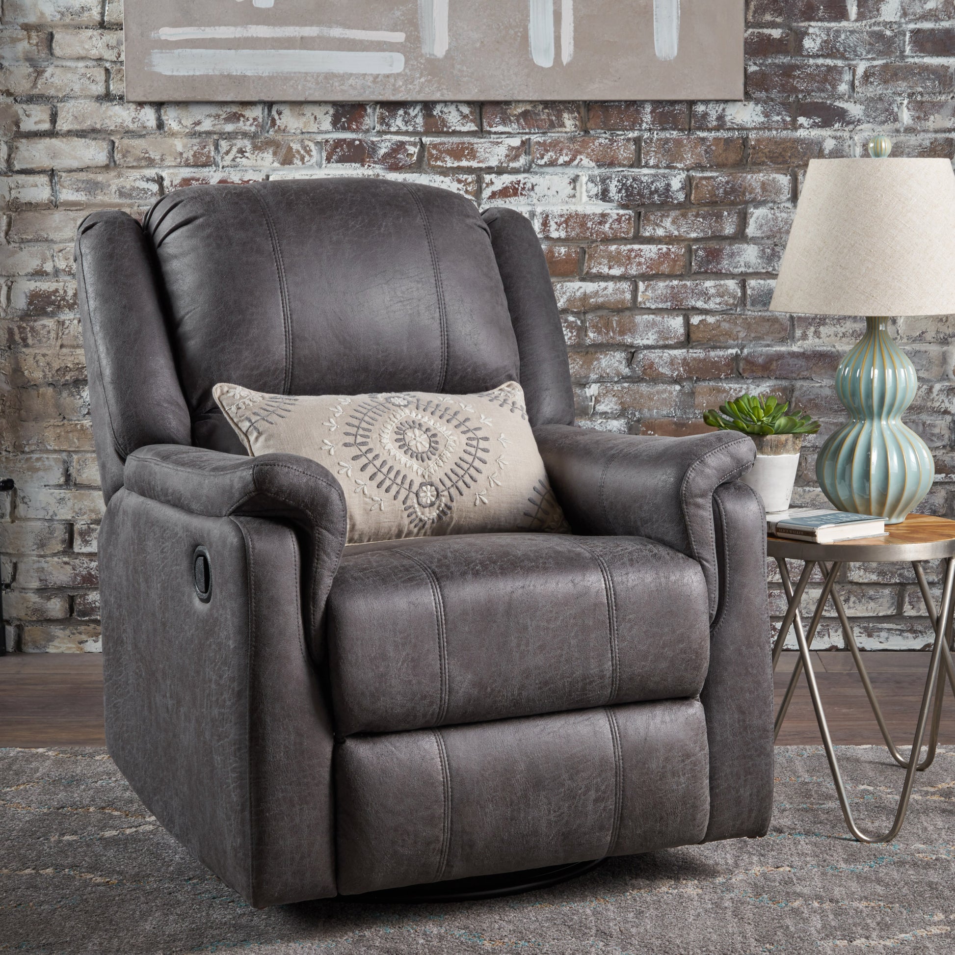 Dark gray faux leather recliner chair with plush cushioning and decorative lumbar pillow