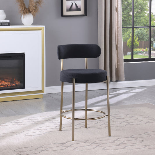 Black textured fabric bar stool with gold metal legs and footrest