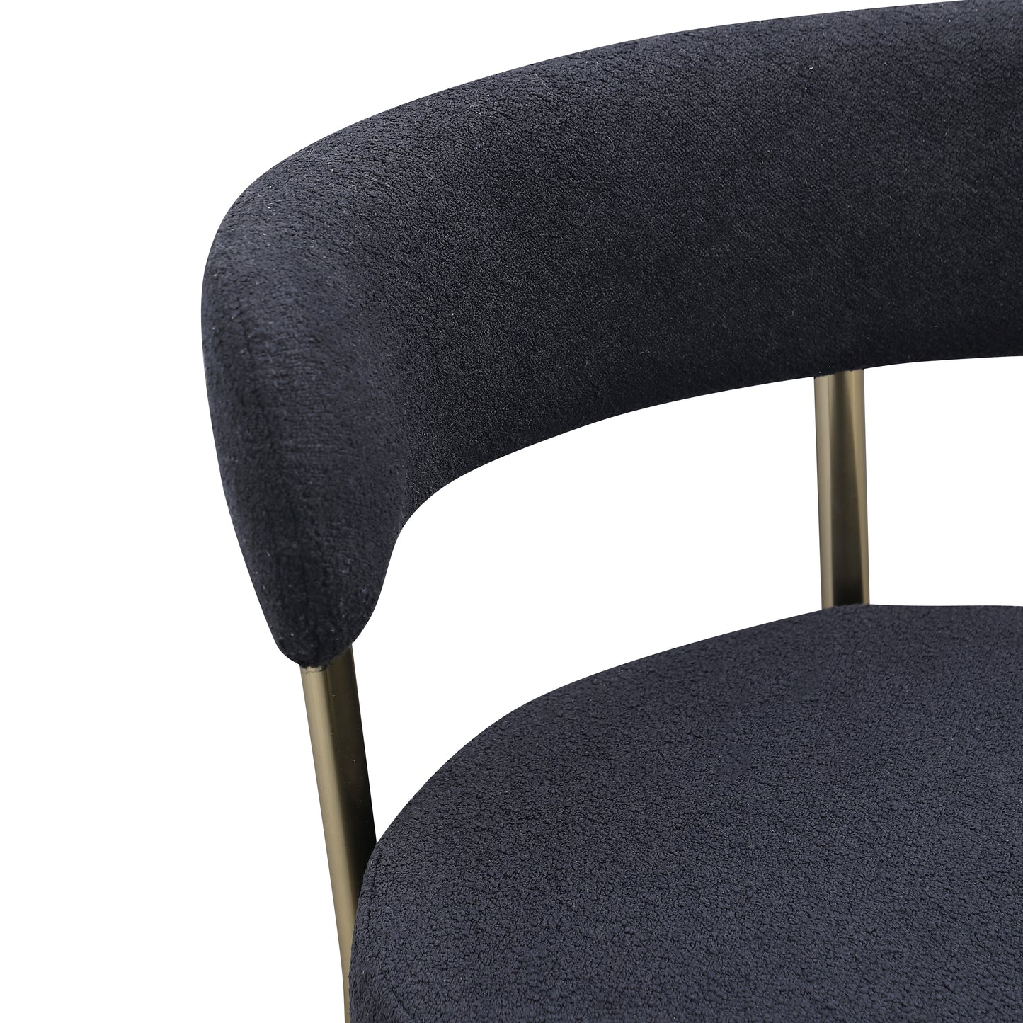 Closeup of dark grey textured boucle fabric armchair with gold metal legs