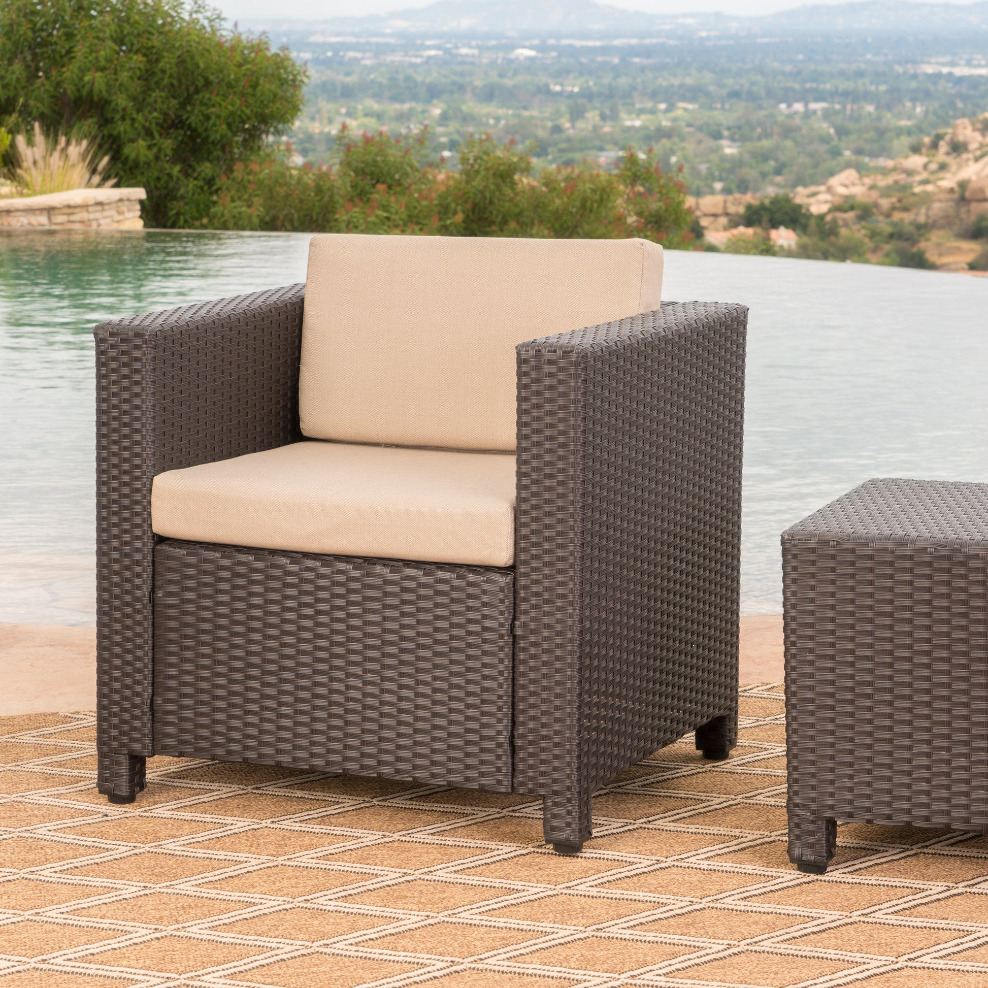Dark brown wicker armchair with beige cushions for outdoor lounging