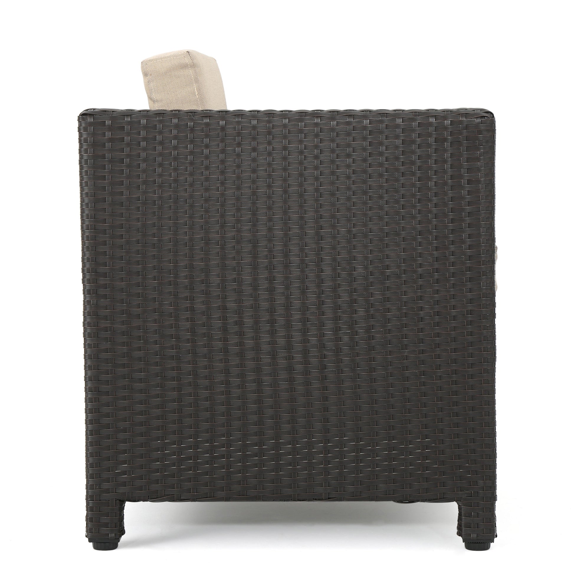 Dark brown wicker armchair side view with beige cushion peek