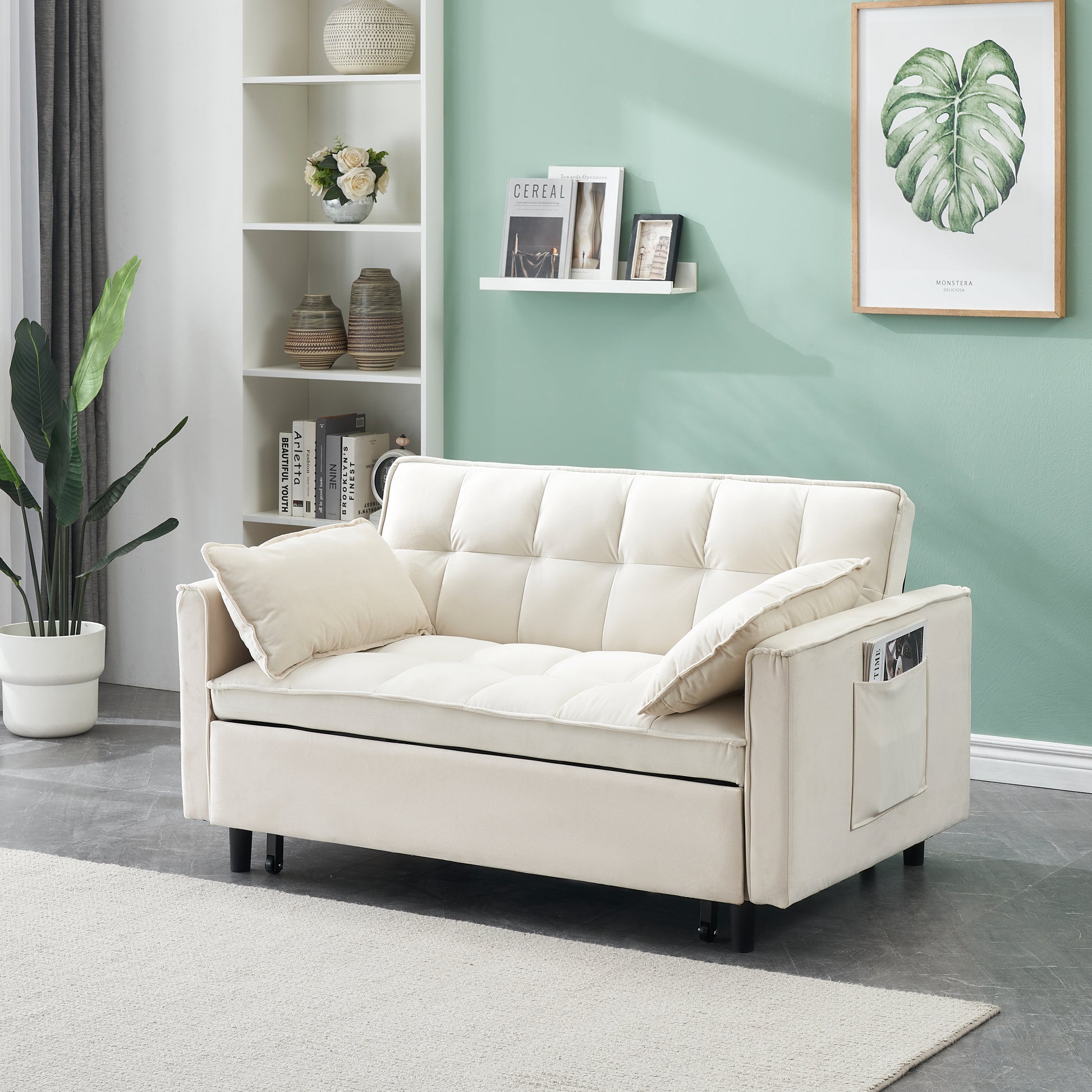 Cream velvet convertible sofa with tufted cushions and builtin side pocket for magazines