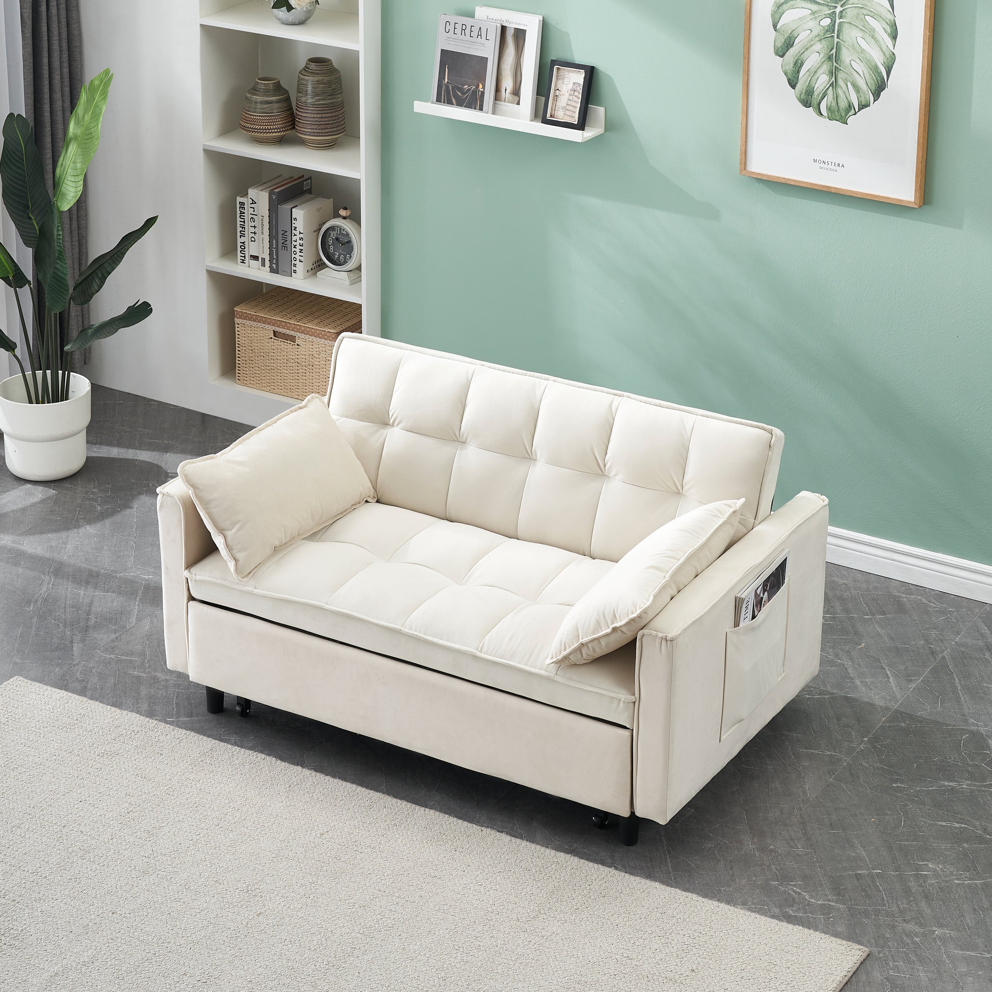 Tufted cream velvet sofa with plush cushions and convenient side pocket for magazines