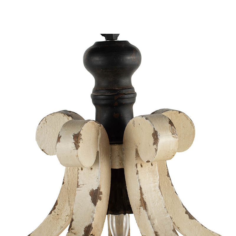 Distressed antique white and dark wood lamp base with ornate scroll details
