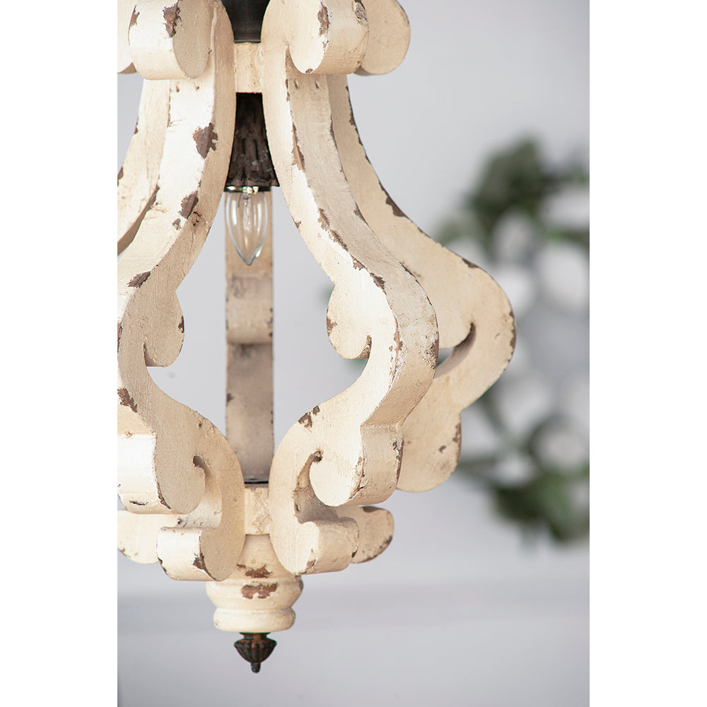 Distressed ivory wood chandelier with scrollwork featuring an exposed bulb and antique finish