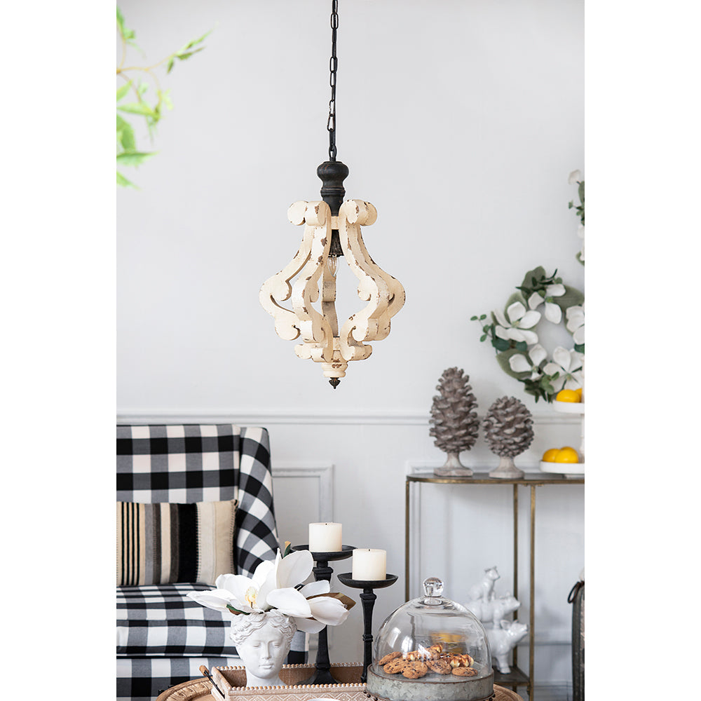 Distressed wood chandelier with ornate white scrollwork and black accents