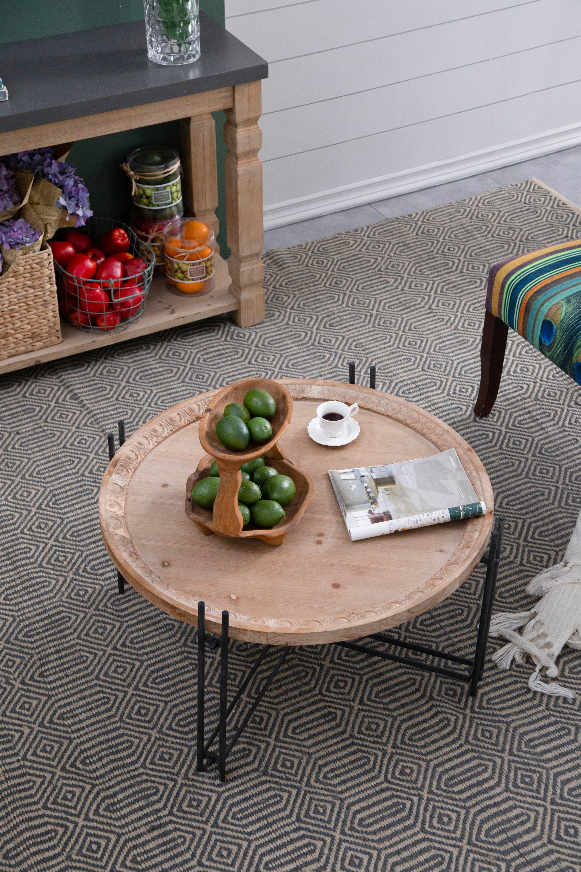 Rustic round wood coffee table with carved edge detail and metal legs