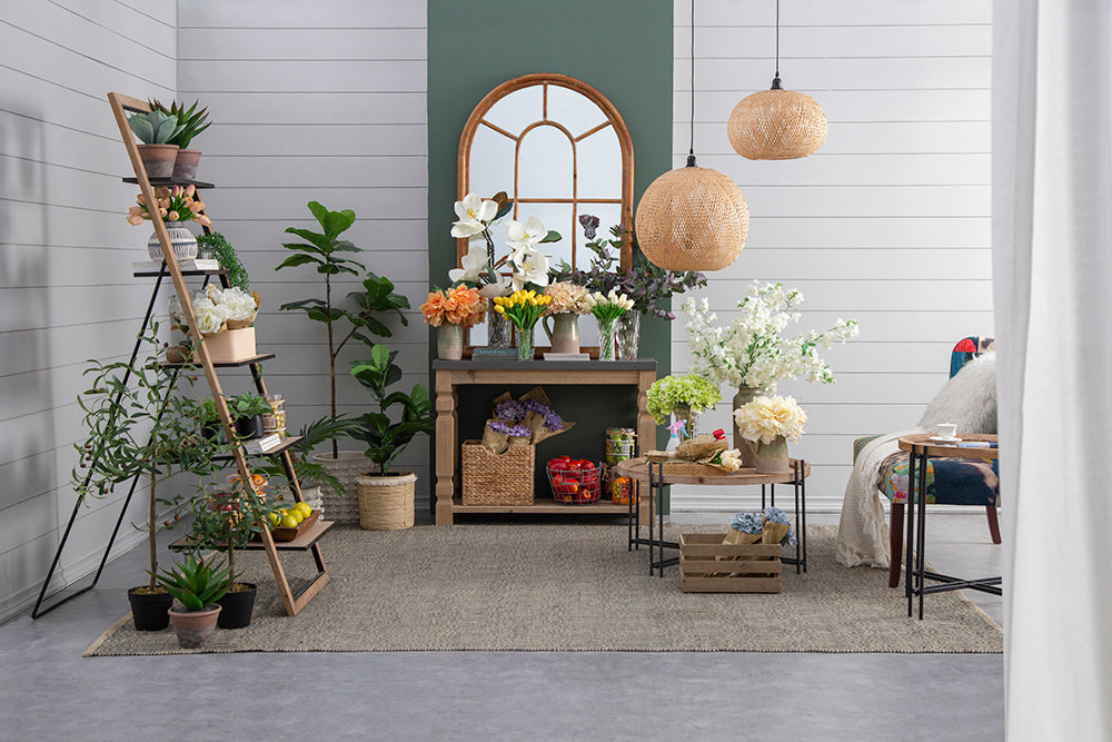 Tiered wooden plant stand with assorted green houseplants and faux flowers