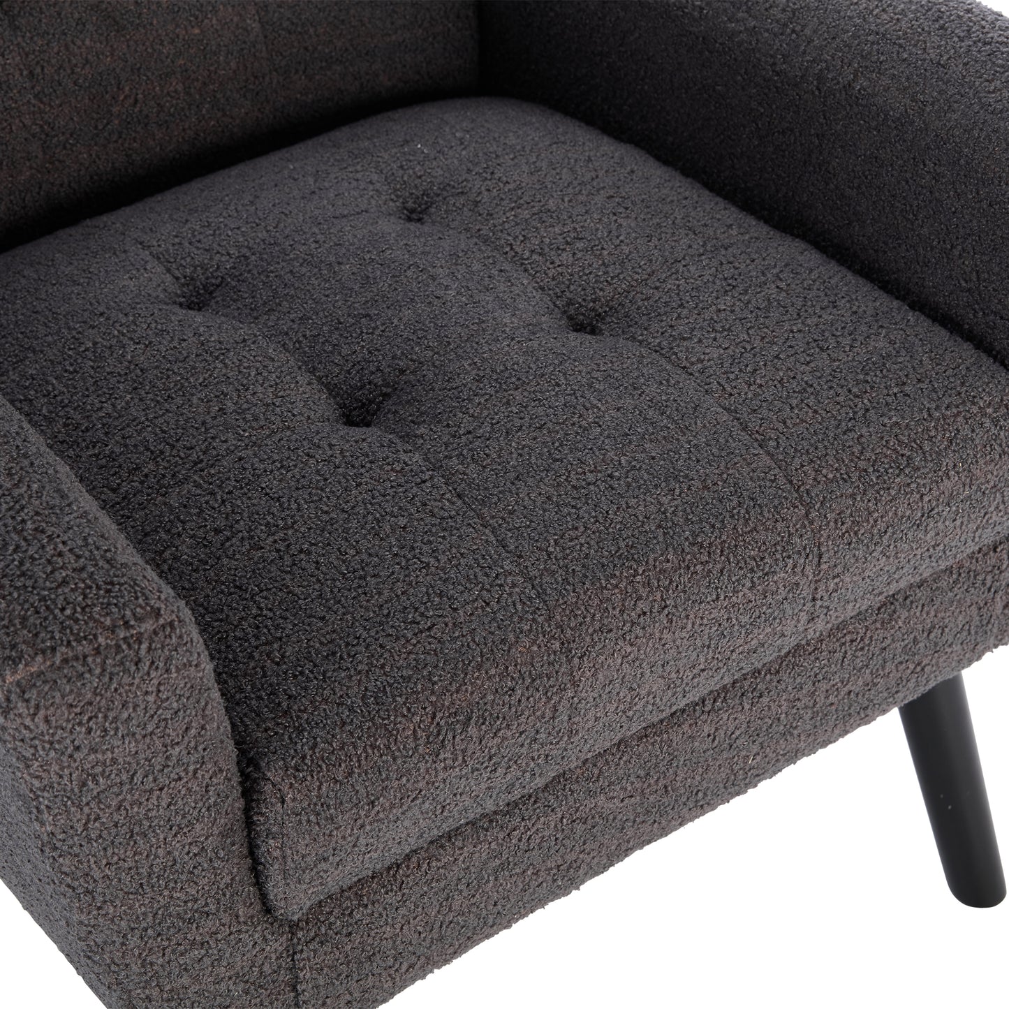 Tufted dark grey boucle armchair seat with black legs